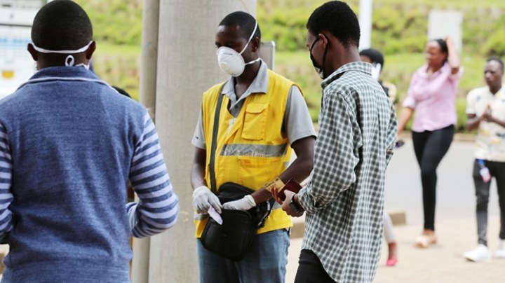 xa-mobile-money-agent-and-his-clients-wear-facemasks-in-kigali-yesterday-craish-bahizi_0.jpg.pagespeed.ic.ySlt23THk6